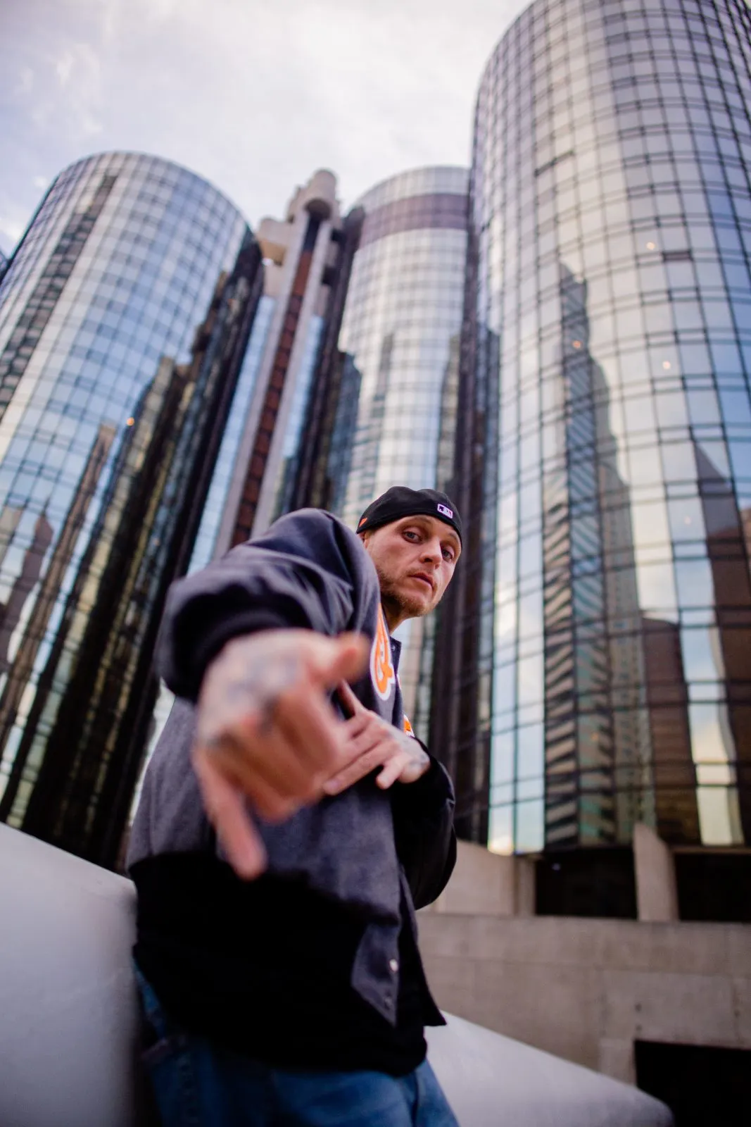 Streetbroker outdoors in Los Angeles, city light behind him.